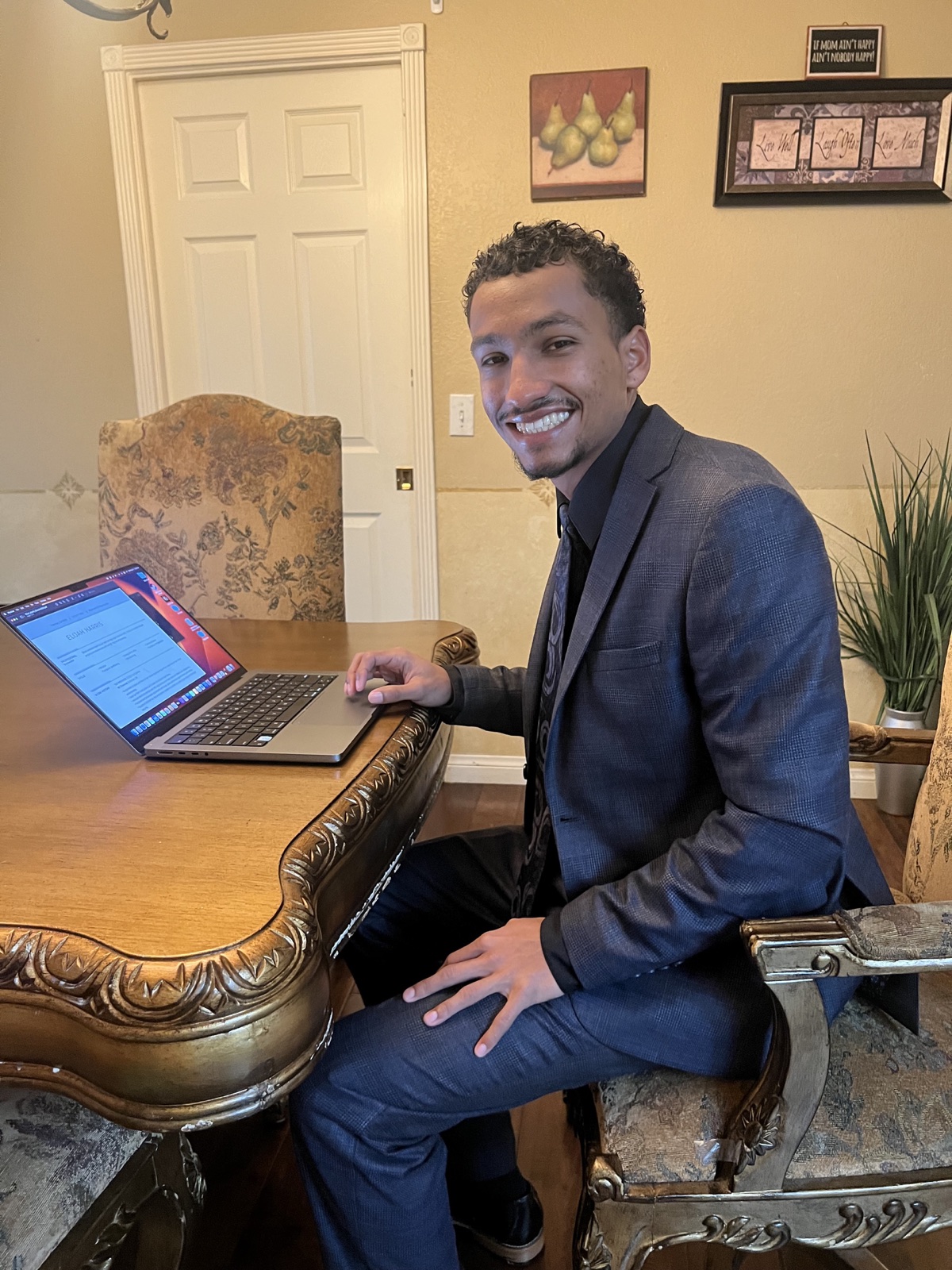 Elijah Harris working with a client tax return on his laptop